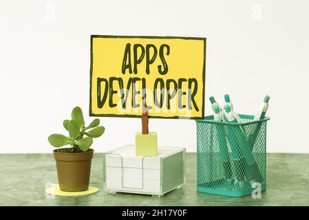 Handwriting text Apps Developer. Word Written on Graphic artist Software Programmer and Analyst Experts Tidy Workspace Setup Writing Desk Tools And Stock Photo