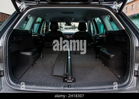 Huge, clean and empty car trunk in interior of a modern compact suv. Rear view of a SUV car with open trunk. Car trunk interior. Stock Photo