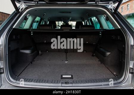 Huge, clean and empty car trunk in interior of a modern compact suv. Rear view of a SUV car with open trunk. Car trunk interior. Stock Photo