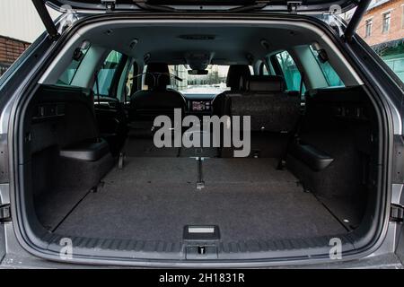 Huge, clean and empty car trunk in interior of a modern compact suv. Rear view of a SUV car with open trunk. Car trunk interior. Stock Photo