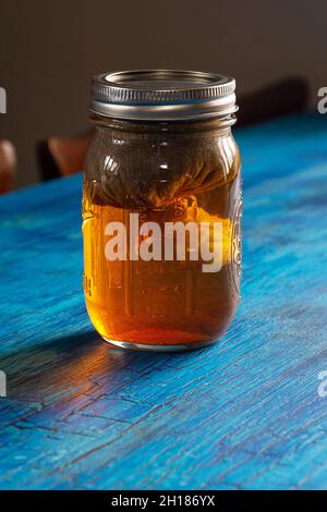 Already Been Vaped ABV AVB Cannabis Hemp Bud Wrapped in Cheesecloth Soaking in Glass Water Cure Jar to Remove Impurities Stock Photo