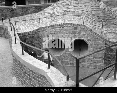 1960s, historical, a concrete made playground area outside a large ...