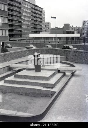 1960s, historical, a concrete and walled playground area outside a large council housing estate, Churchill Gardens in Pimlico, inner London, England, UK. Built between 1948 and 1962 to replace victorian terraces damaged in the Blitz of WW2, this was a huge estate of social housing, with 32 tower blocks providing 1,600 homes. Outside the flats, a walled enclosure with a concrete playground area and sandpit shaped as a boat. Stock Photo