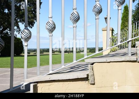 View through the decorative silver railing at the countryside beyond Stock Photo