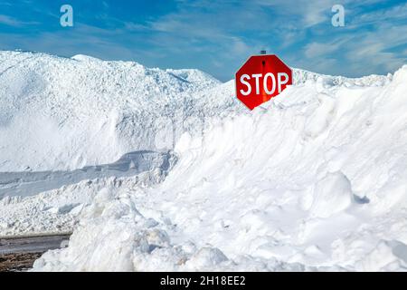 Stop sign in a snowbank. Stock Photo