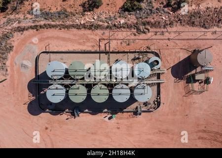 An aerial view of an storage tank battery on an oil well location in the canyon country of Utah. Stock Photo