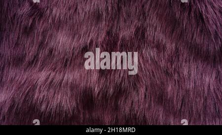 Detail of a dark purple-coloured synthetic fur material. Stock Photo