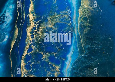 Resin art with deep blue and golden colors. Epoxy effect background Stock Photo