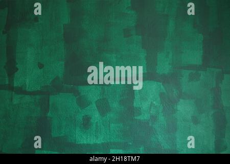 Unfinished painted wall with green color, home repairs. Texture showing paint roller traces. Stock Photo
