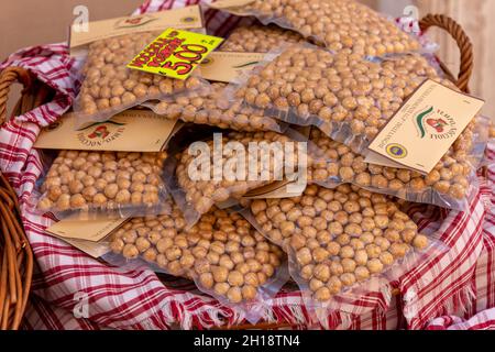 Alba, Cuneo, Italy - October 12, 2021: Piedmont IGP hazelnuts from Langhe, round and gentle,  toasted in vacuum packed sealed on sale Stock Photo