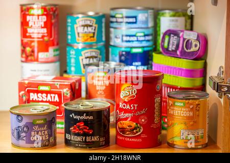 Tinned or canned foodstuffs in a UK kitchen cupboard, stocked up, storage, provisions Stock Photo