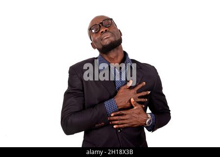 a handsome young businessman in suit standing on white background with shocked look. Stock Photo