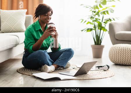 Black Female Video Calling Or Watching Lecture On Laptop Indoor Stock Photo