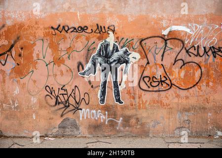 Street art. Torn cut-to-shape paste-up posters in Trastevere district of Rome, Italy. Stock Photo