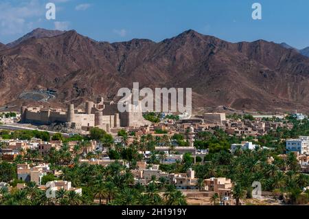 The Bahla fort, built in 13th century, and a palm tree. Bahla, Oman ...