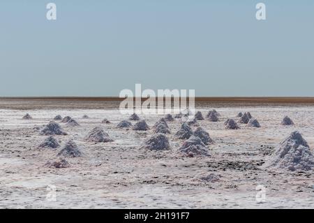 Piles of salt harvest in the salt flats near Shannah. Shannah, Oman. Stock Photo