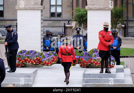 Halifax, Nova Scotia, Canada. October 17th, 2021. RCMP officers, lay a wreath on behalf of their troop in honour of Nova Scotia Peace Officers who died in line of duty. This marks the 39th annual Peace Officers' Memorial, held at the Grand Parade in downtown Halifax. The event honours peace officers based in Nova Scotia who died in the line of duty and is a humbling reminder of their selflessness and dedication. Credit: meanderingemu/Alamy Live News Stock Photo