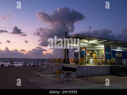 Paphos Lighthouse beach cafe at dusk, Paphos, Cyprus. Stock Photo