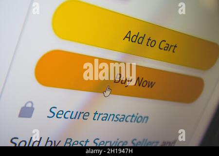 Buy now button on screen. Buying items online on amazon or ebay Stock Photo