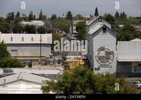 Madera, California, USA - July 15, 2021: Afternoon sun shines on a historic industrial district of Madera. Stock Photo