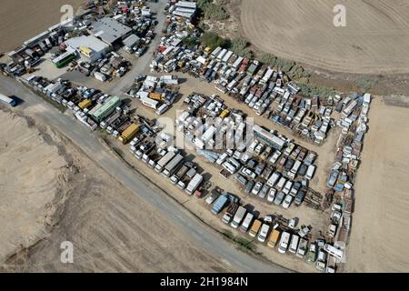 Aerial drone top view of smashed destroyed car wrecks on car junkyard. Stock Photo