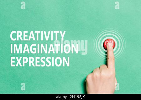 A person hand pushing red button - Switch on or Turn on creativity, imagination, expression Stock Photo