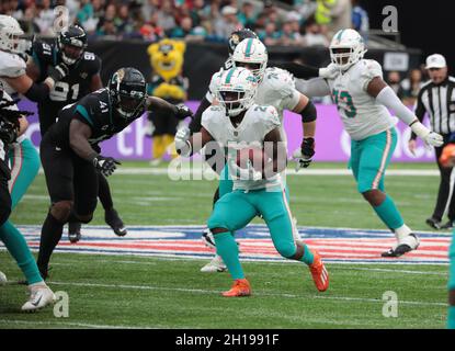 August 19, 2023: Miami Dolphins running back Salvon Ahmed (26) carries the  ball as Houston Texans safety Jimmie Ward (1) looks on after missing a  tackle during an NFL preseason game between