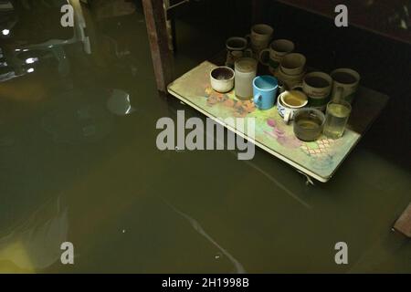 Bangkok, Thailand. 17th Oct, 2021. A submerged table is seen in one of the homes in Santichon Songkroh community.Santichon Songkroh community, a small community along Bangkok Noi Canal is now facing daily flood influenced from water walls leakage and heavy rainfall from Tropical Storm Kompasu. Credit: SOPA Images Limited/Alamy Live News Stock Photo