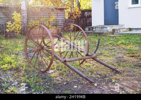 Old retro metal cart in the garden close up Stock Photo