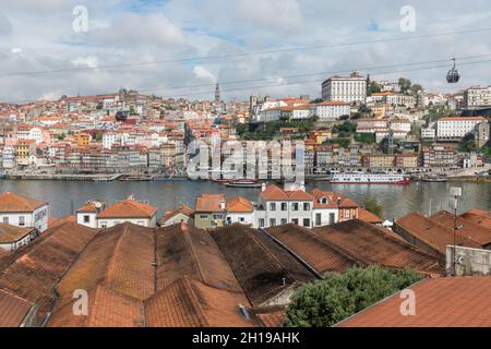 Porto Portugal,view with rooftops of Port wine cellars in Vila Nova de Gaia, Ribeira district of Porto behind at River Douro, Portugal. Stock Photo