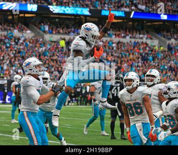 Miami Dolphins wide receiver Jaylen Waddle (17) catches a pass and turns to  make the touchdown during an NFL International Series game against the  Jacksonville Jaguars at Tottenham Hotspur Stadium, Sunday, Oct.