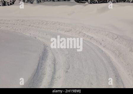 The traces of deep wheels in freshly fallen snow Stock Photo