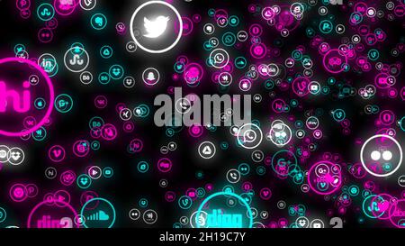 Colorful abstraction of popular social networks and services app icons floating on the black background. Technology, social media and internet backdro Stock Photo