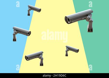Few security cameras on colorful wall. Minimal creative concept. Stock Photo
