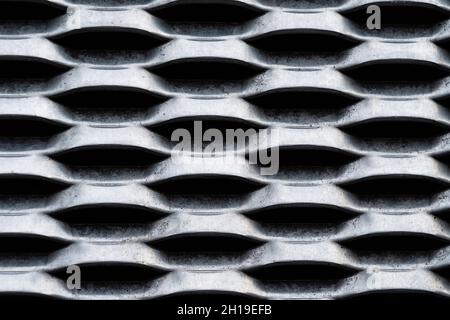 Background of a gray metal industrial grill on the facade of a house Stock Photo