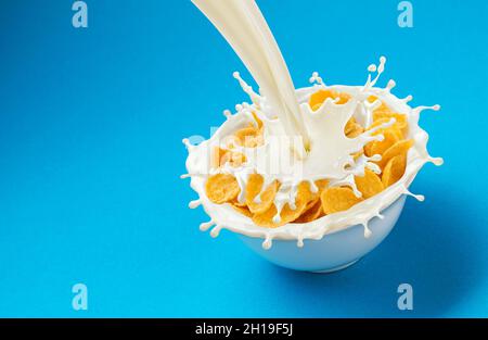 Corn flakes with pouring milk and copy space Stock Photo