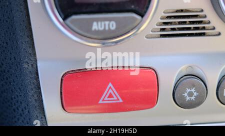 4-way flasher red button inside the car Stock Photo