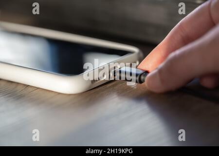 Magnetic cable for charging smartphone, close up. Stock Photo
