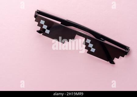 Meme Pixel glasses on pink background. Minimal concept. Stock Photo