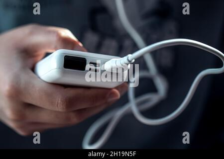 Close-up of a white power bank in a female hand. Stock Photo