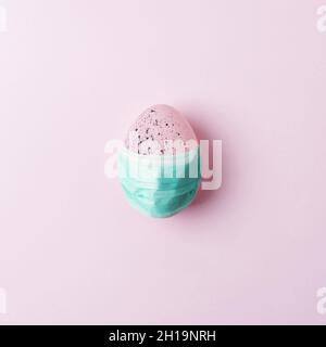 Colorful Easter egg on pink background. Minimal Easter concept. Flat lay. Stock Photo