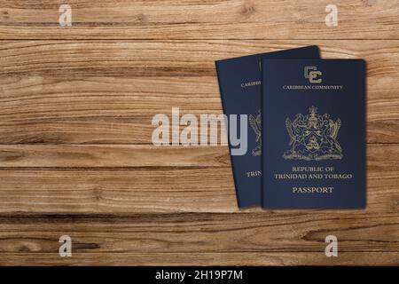 Trinidad and Tobago passports are issued to Trinidad and Tobago citizens for international travel, two passports on a wooden background Stock Photo