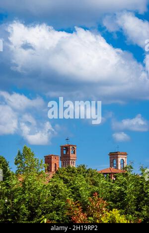 Lucca charming historical center skyline with beautiful clouds and medieval towers rises above surrounding anciet walls park trees Stock Photo