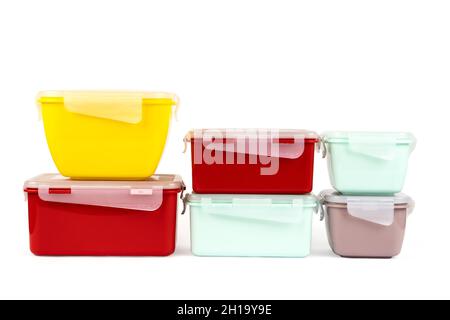 Stack of plastic multi-colored containers for food products isolated on white background. Side view Stock Photo