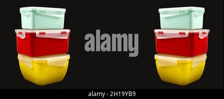 Multicolored plastic lunch boxes on a black background from both sides, banner Stock Photo