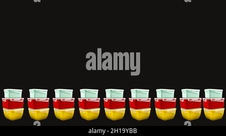 Multicolored plastic lunch boxes on a black background from both sides, banner. Copy space Stock Photo