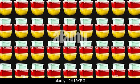Yellow, mint and red plastic lunch boxes on a black background. Pattern Stock Photo
