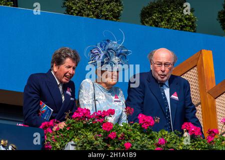 Ascot, Berkshire, UK. 16th October, 2021. Her Majesty the Queen's Racing Manager John Warren (left) with Mr and Mrs Christopher Wright in the Royal Box. Credit: Maureen McLean/Alamy Stock Photo
