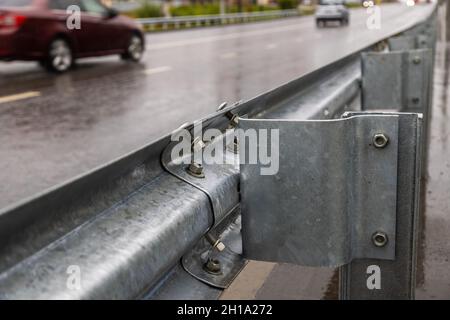 underscrewed nuts and bolts in highway road railing Stock Photo