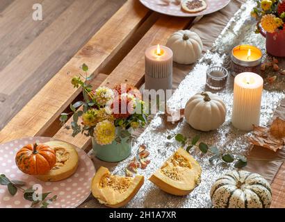 Festive table setting with pumpkins and chrysanthemum flowers. Stock Photo